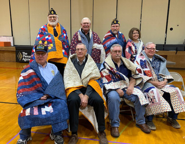 Quilts of Valor recipients: Back row: Scott Anderson, Sherman Wilshusen, Doug Jones, Pat Pedersen. Front row: Richard Kropatsch, James Varney, Gregory Heindreyx, Allen Pedersen. Photo provided