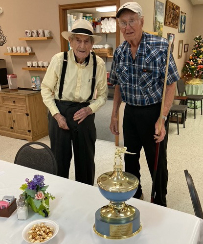 Harvey McHarry (age 100) and Leonard Anderson (age 91) are two pool players from Polk that helped win the County Pool Traveling Trophy to take home to Polk. Photo provided.