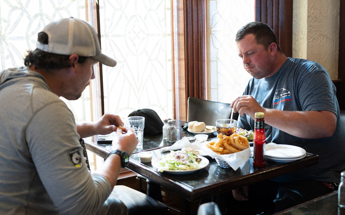 Above: Friends Shane Bender (left) and Chris Kraft dig into salads, sodas and a basket of onion rings in the Hob-Nob Lounge at Chances “R” Restaurant and Lounge in York. Kraft, a Colorado resident, happened to be passing through on the same day that Bender was in town from Ogallala for training for his job with the Nebraska Public Power District. Photo by Liz McCue for the Flatwater Free Press