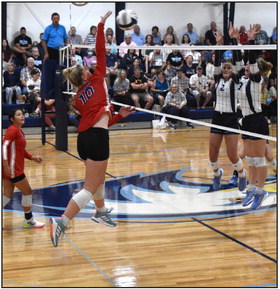 Courtney Carlstrom goes up for a kill against Nebraska Christian’s block with Gahvi Lesiak watching. PCN photo by Beth Sparrow.