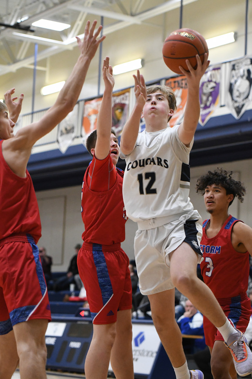 LEFT: Ashton Seim drives for two of his team-high 13 points of Cross County. PCN photos by Rick Holtz