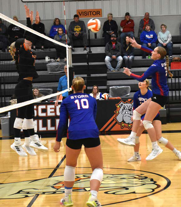 Rylee Hofmann gets a kill and tries to get it past Osceola’s block. PCN photo by Beth Sparrow.