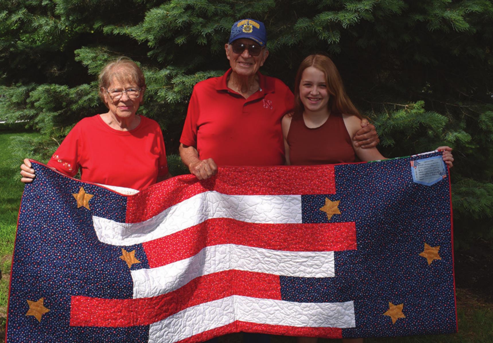 Pictured is veteran Jim McLean (middle), his wife Alice (left) and Olive Peterson (right) who made the quilt. Olive is a great-niece of Jim’s.