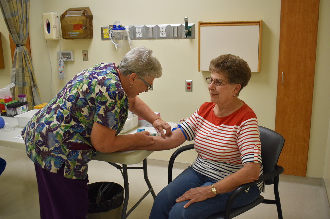 The Annie Jeffrey Health Fair was on Tuesday. Here lab tech Donna Hellbusch draws blood from participant Sheila Grossnicklaus. Photo by Beth Sparrow.