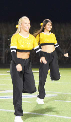Left- Olivia Fredrick and Adelyn Favors dance during half time of the Neligh Oakdale at SRC football game. Charlie Thompson and Ashlyn Long perform on the field at halftime. PCN photos by Beth Sparrow.