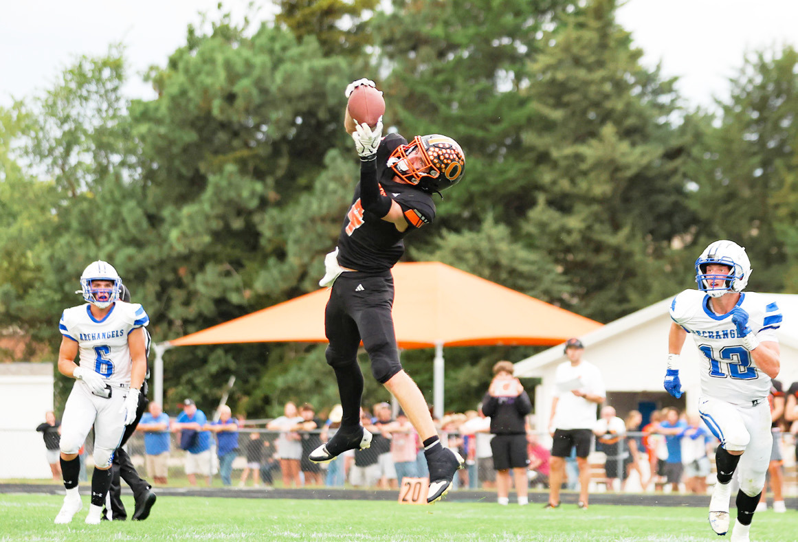 Osceola junior Landan Drozd climbs the ladder to snare this pass in the Bulldogs game with Archangels Catholic this past Friday night. Drozd had three receptions for 61 yards and led the defense with eight tackles. PCN photo by Blaine Winslow.