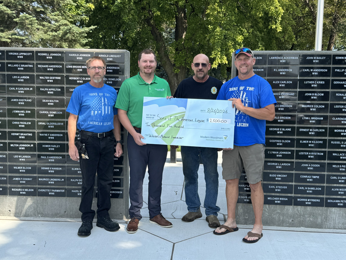 Aaron Giannou with Modern Woodmen matched funds of $2500 for the Sons of the Legion memorial wall. Here is Giannou presenting a check to some members. Photo provided.