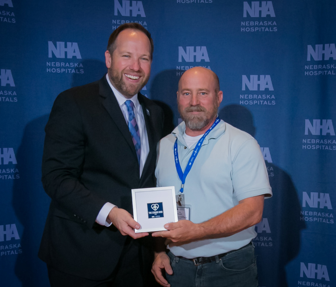 Lou Neujahr (right) received the Caring Kind Award for AJMHC from the Nebraska Hospitals Association. Photo provided by AJMHC