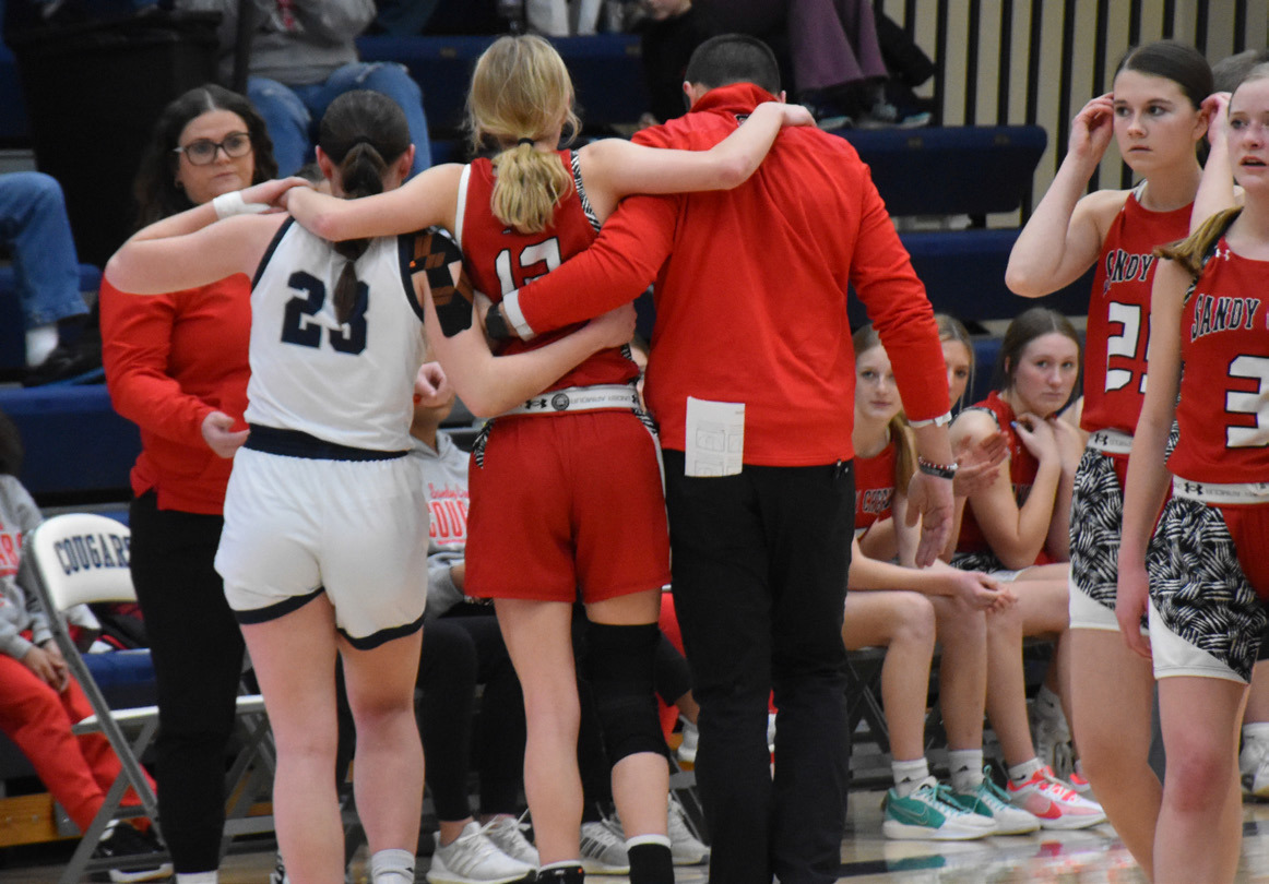 Kelley helps an injured Sandy Creek player to her bench. PCN photo by Beth Sparrow. Just one example of good sportsmanship this week as Lindee