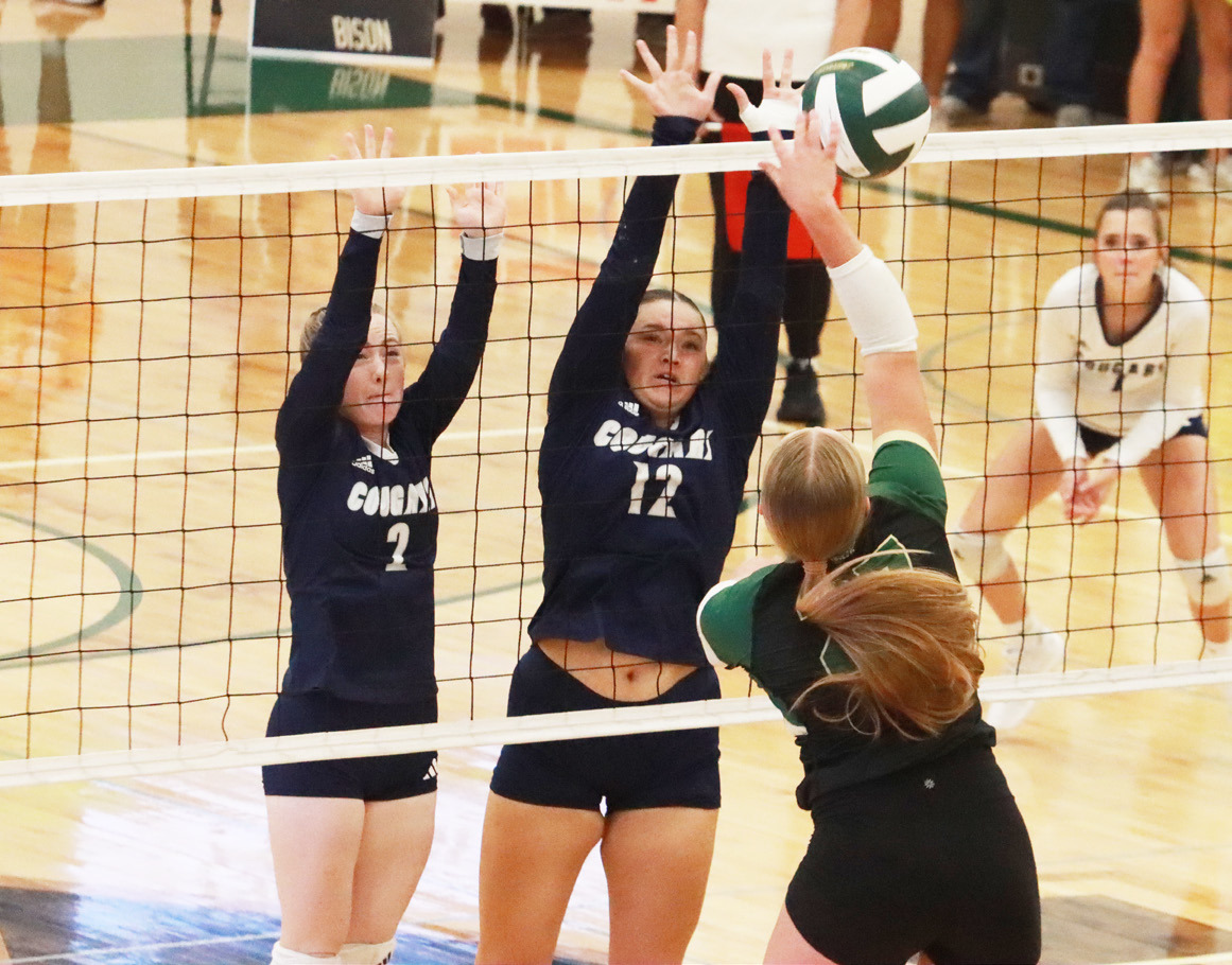 Above- Cross County sophomore Piyper Berggren (2) and senior Cortina Donnelly (12) combine on the block. Right- Cougars senior Ava Pruter attacks the Central City defense during Thursday’s match. PCN photos by Ken Kush