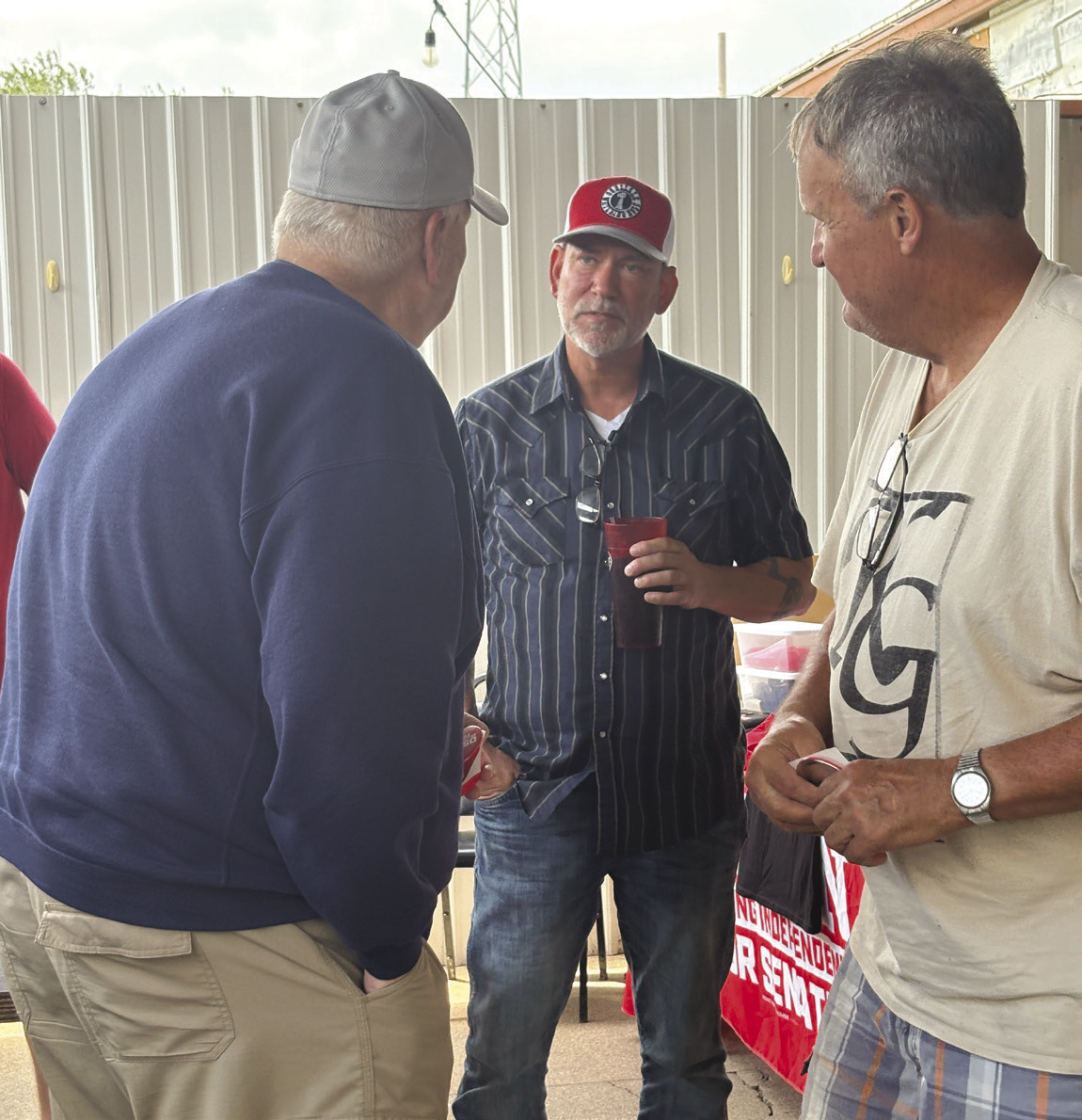 Dan Osborn talks to local people, Bob Waltman and Tim Alvis, on Friday at El Centenario in Stromsburg. PCN photo by Beth Sparrow.