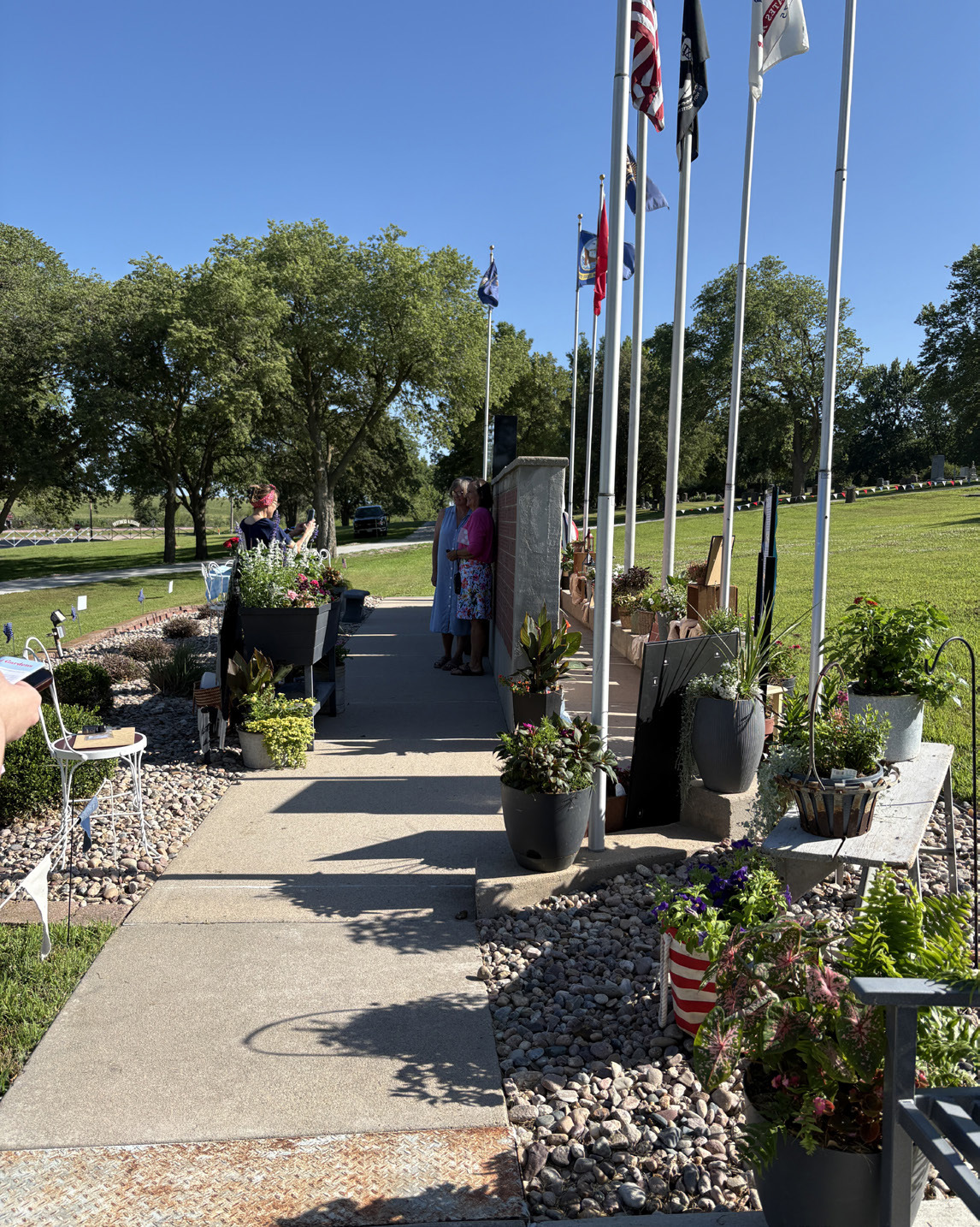 Above: The Osceola garden tour included a stop at the cemetery to see these beautiful flowers. Vicki Jones as “Rosie the Riveter” was on hand to stamp “passports” and help. Below: The garden at Good Sam Nursing Home was also on the tour. PCN photos by Beth Sparrow.
