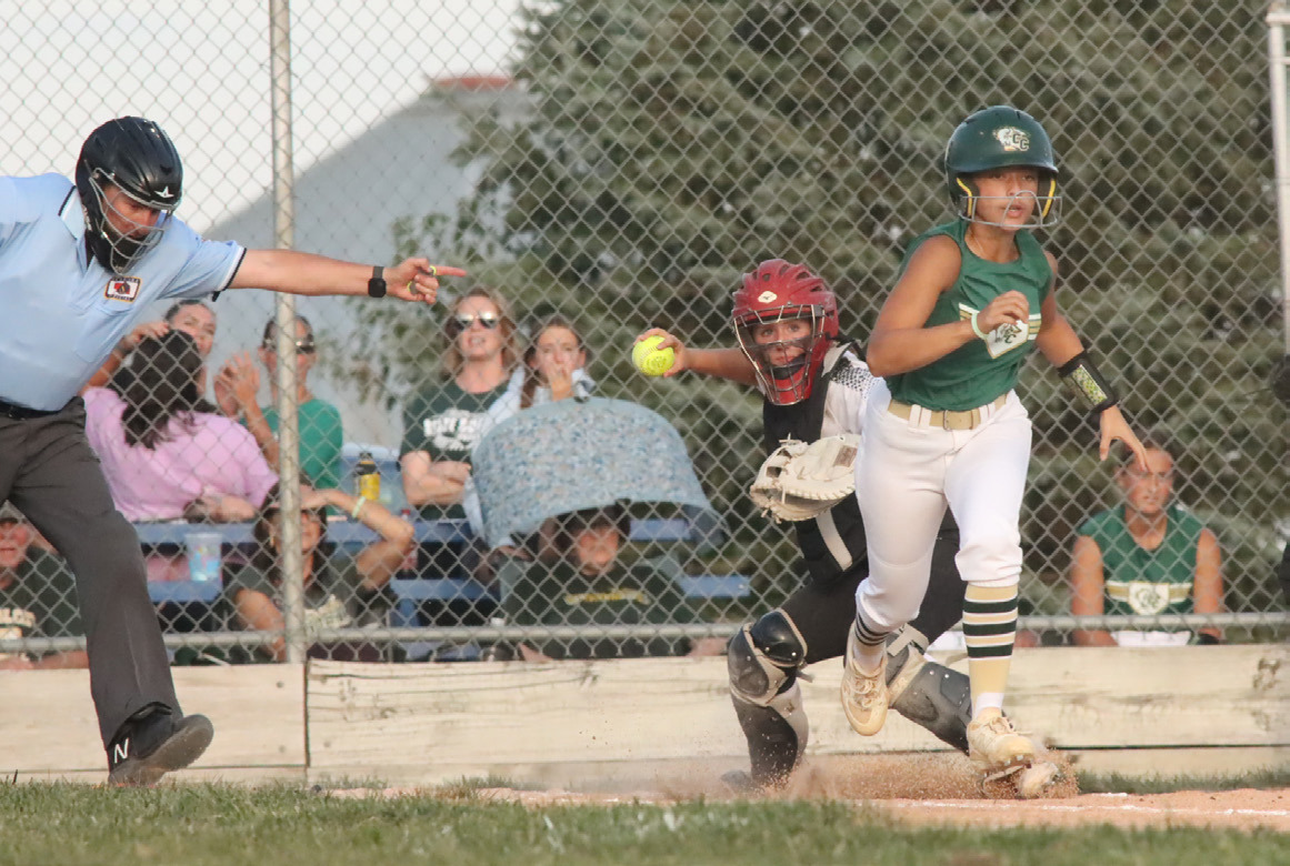 Polk County senior catcher Mady Berggren picks up the ground ball in front of home plate ands fires on to first base. In two games this week Berggren was 5 for 6 with two home runs, a triple and six RBI’s. PCN photo by Ken Kush.