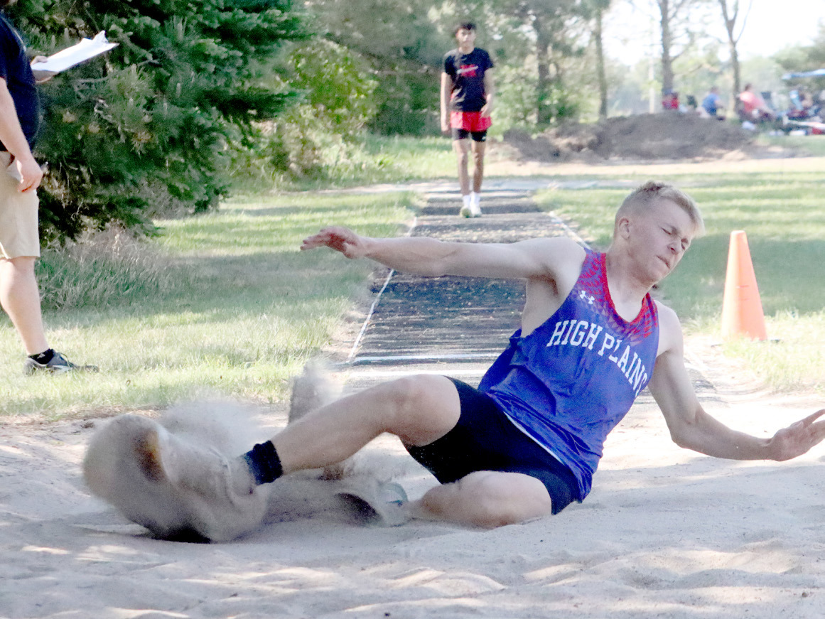Top: High Plains junior Brodey Spurling splashes down into the pit in the triple jump. Spurling won both the triple and the long jump on Wednesday. He also was on the Storm’s 4x100 relay which also qualified. 