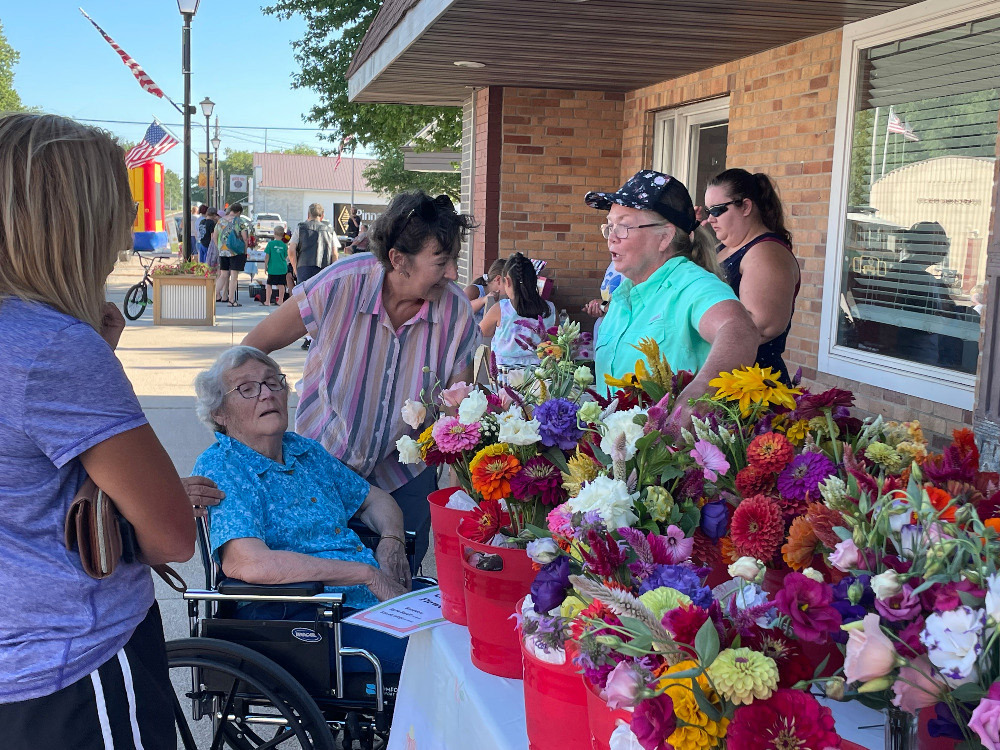 Ladies at the Farmer's Market enjoyed looking at these flowers. Photo by Rick Holtz.