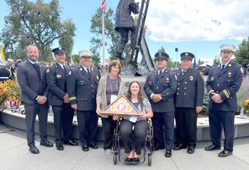 Above: Erika Burritt holds the award presented to them in honor of her father. Pictured are Gary Bruns (IAFF Neb. St. Pres.), Tom Rathje, JoJo Dunn, Aaron Perez, Dave HOgelin, Derek Salak. Below: David Burritt’s name incribed on the wall. Photos provided.