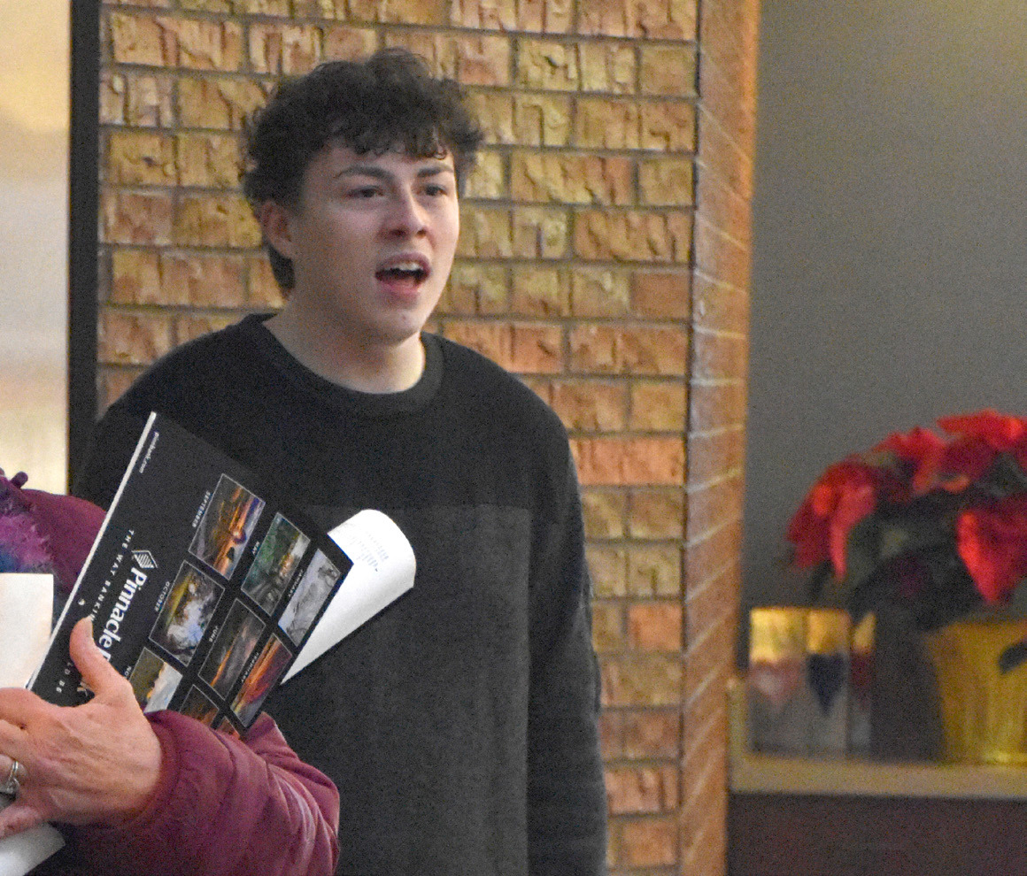 SRC students sang or played instruments with Christmas music inside Pinnacle Bank. Pictured is Uriyah Grant. PCN photo by Beth Sparrow.
