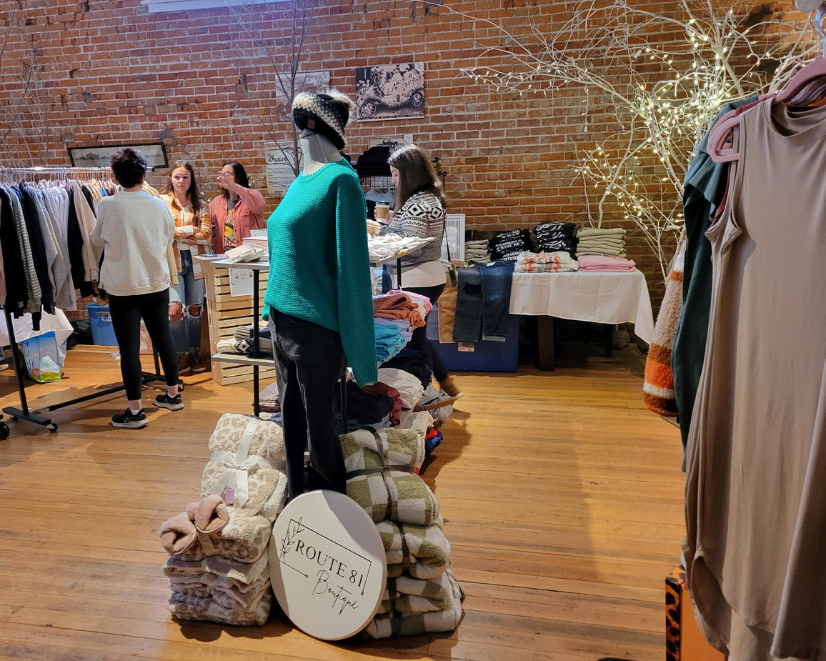 Shoppers enjoyed local retailers on Saturday morning. Above: Route 81 Boutique was set up in 4th Street Coffeehouse. Below: Four local people were set up in the Polk County News building including Blue Eyed Boutique. PCN photos by Beth Sparrow.