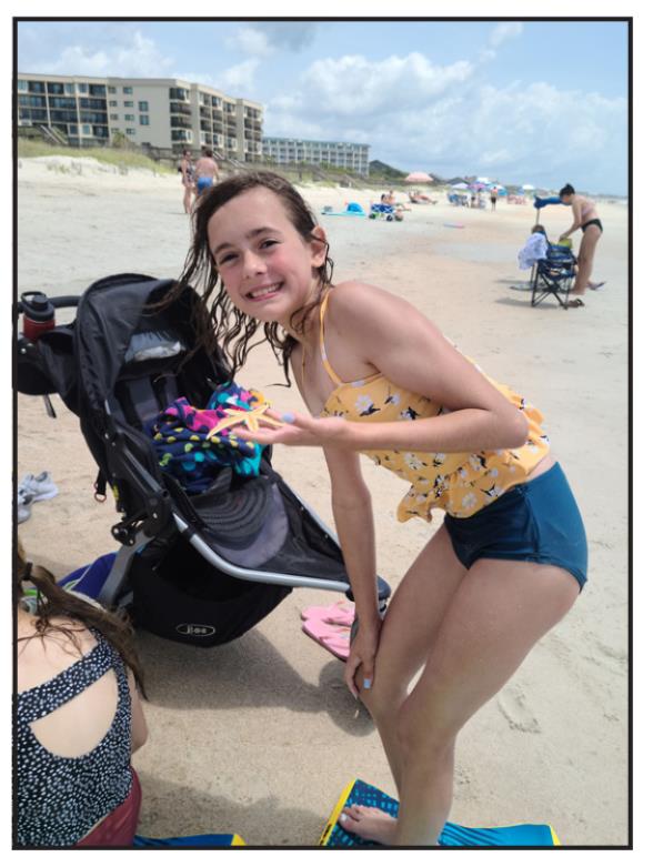 Ella Cramer shows off a star fish found on the beach on Pawleys Island, South Carolina.