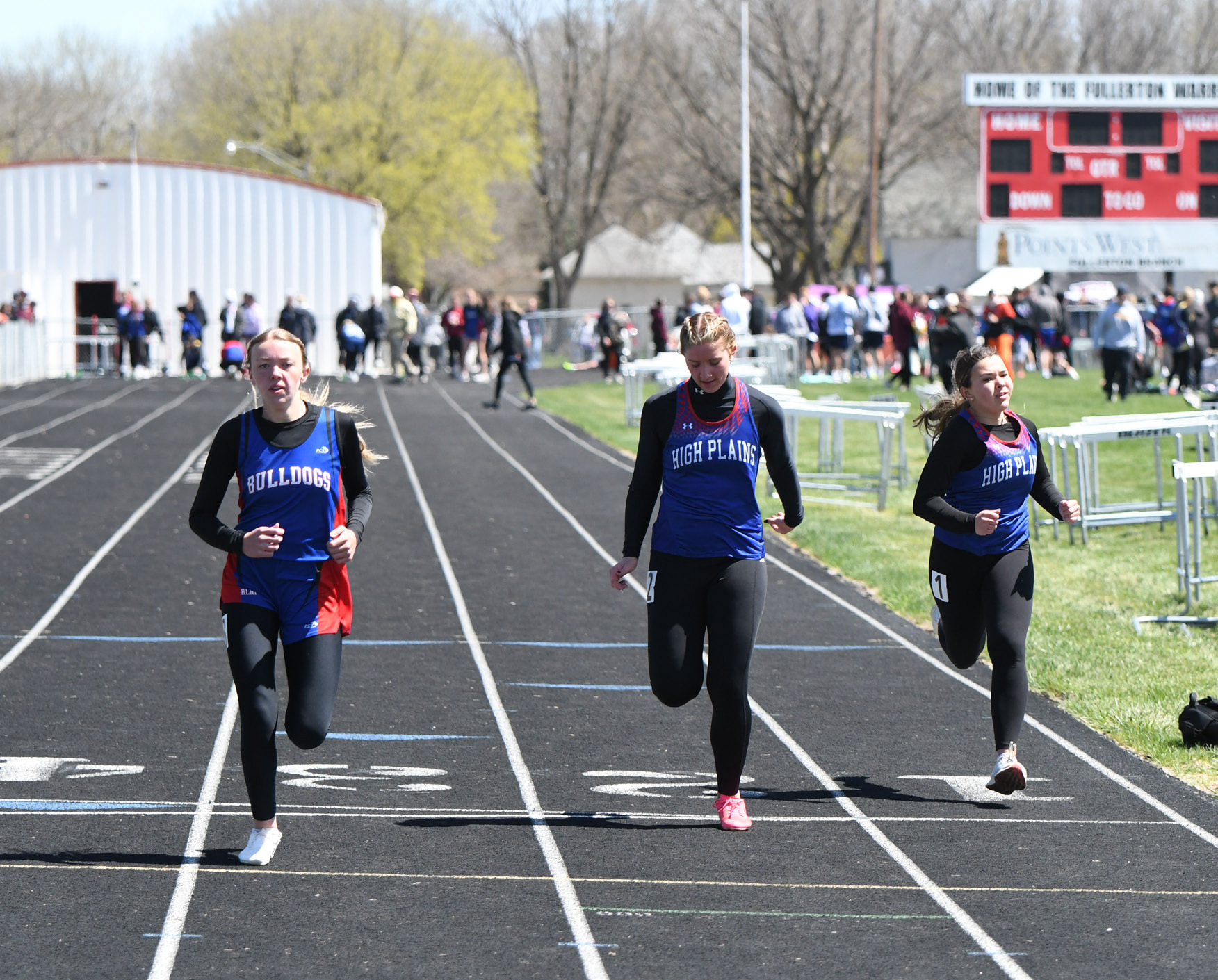 Courtney Carlstrom (HPC) finishes just ahead of teammate Jacey Dubas in the 100m dash. PCN photo by Rick Holtz.