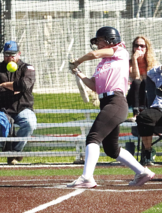 Top left- Blue River’s Jayden Hayes singles to center moving two runners into scoring position during Friday’s game in Lincoln. Top right- Lead-off hitter Taylor Slonecker gets the first of her two steals against Raymond Central. PCN photo by ken Kush.