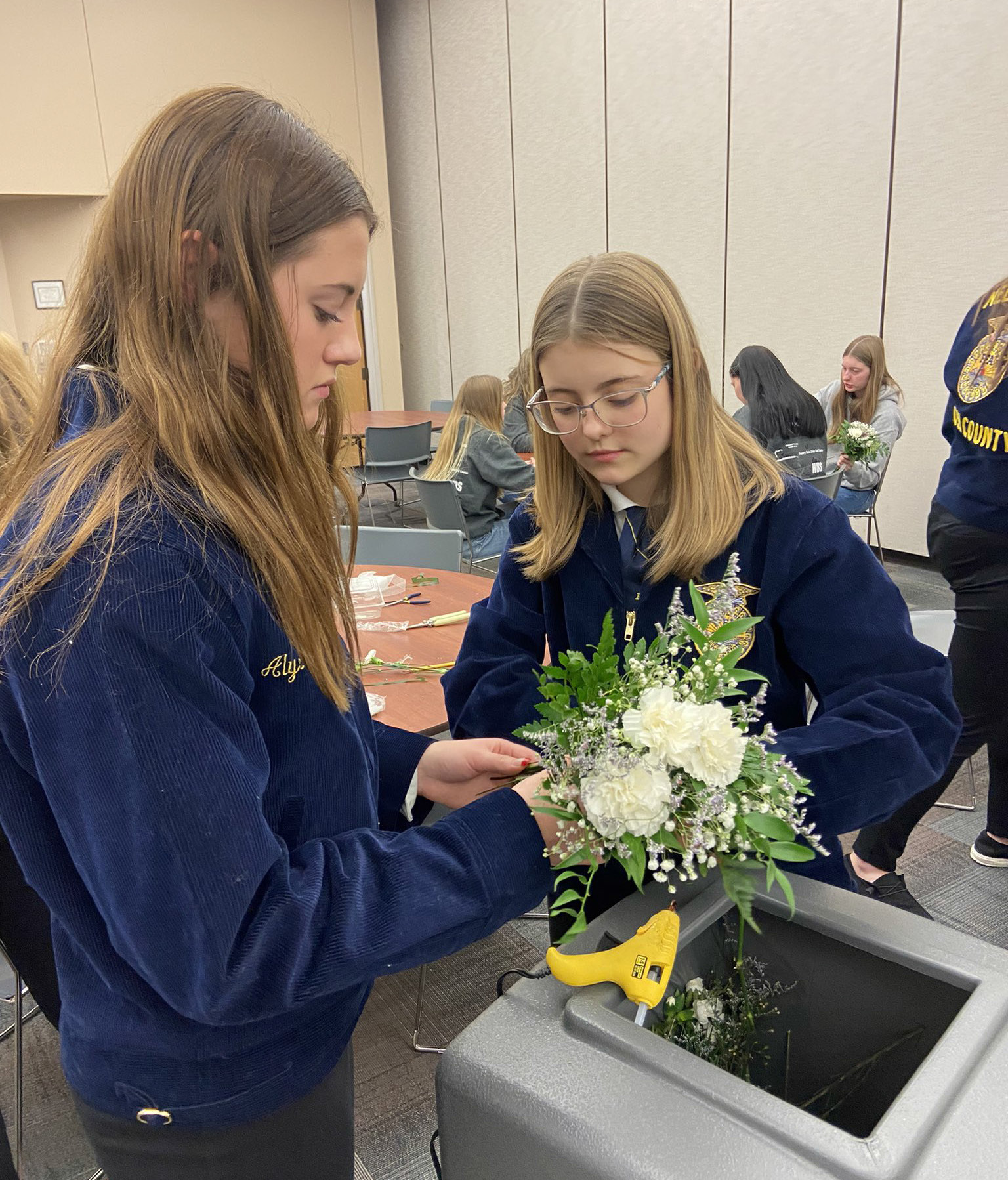 Alyssa Renken and Ava Cramer work on their Floriculture display. Cross County Schools photo