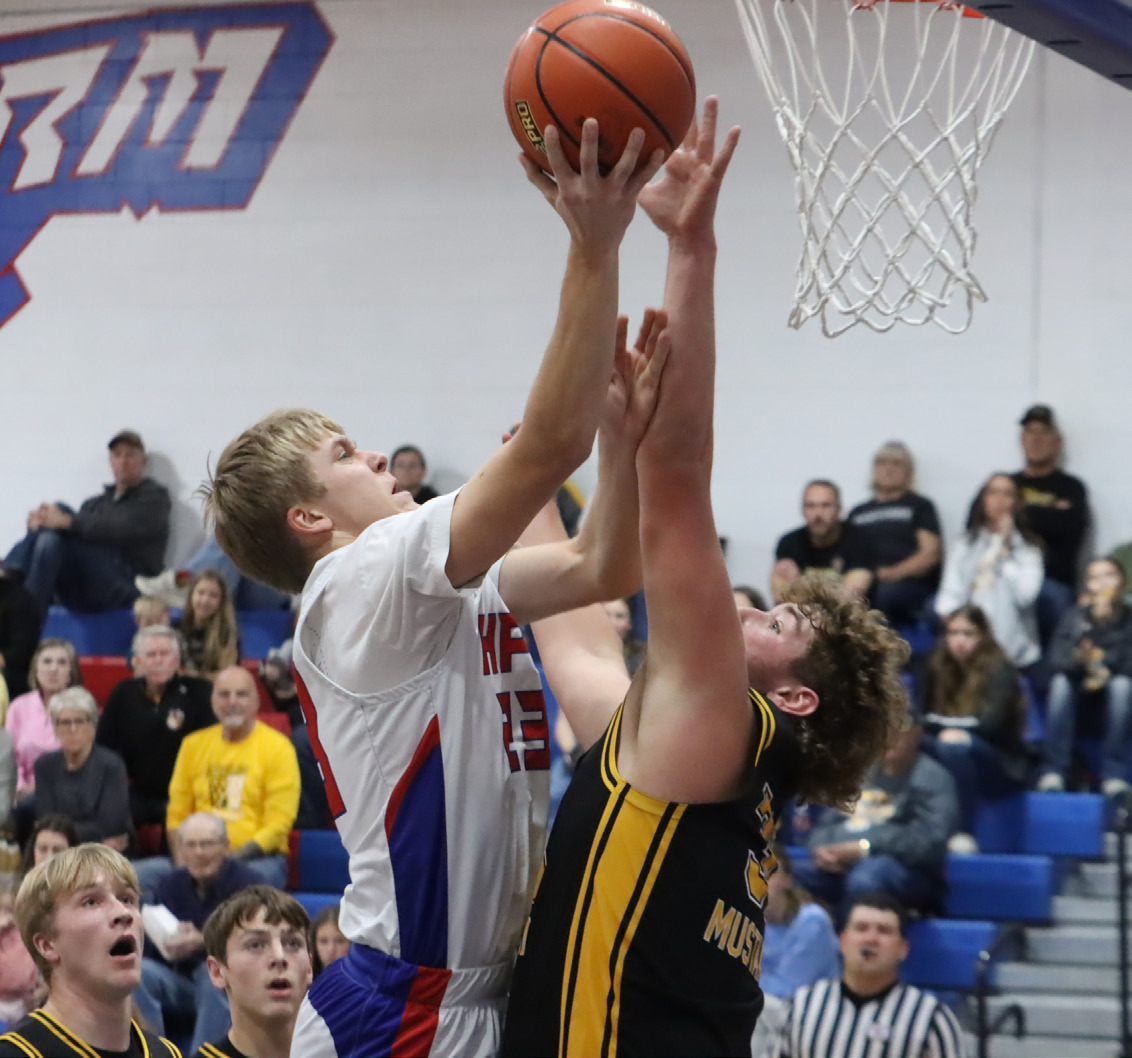 High Plains senior Brodey Spurling (23) is contested at the basket by McCool Junction senior Dylan Gonnerman. Spurling led the Storm with eight points in the loss to the Mustangs and he scored 16 in the win over Dorchester. PCN photo by Ken Kush.