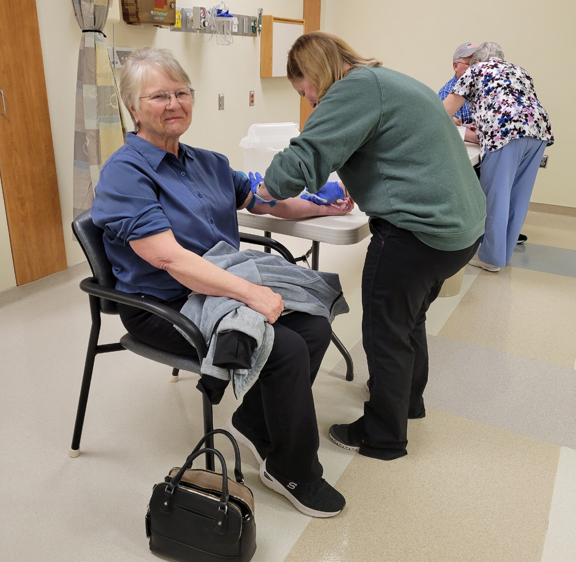 Nurse Kim Yungdahl draws blood from Susan Sundberg of Polk who participated in Annie Jeffrey’s annual health fair on Tuesday. PCN photo by Beth Sparrow