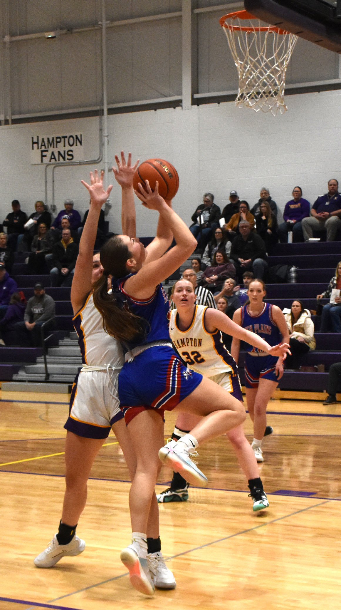 Rylee Ackerson goes for a shot as a Hampton girl tries to stop her. PCN photo by Beth Sparrow.
