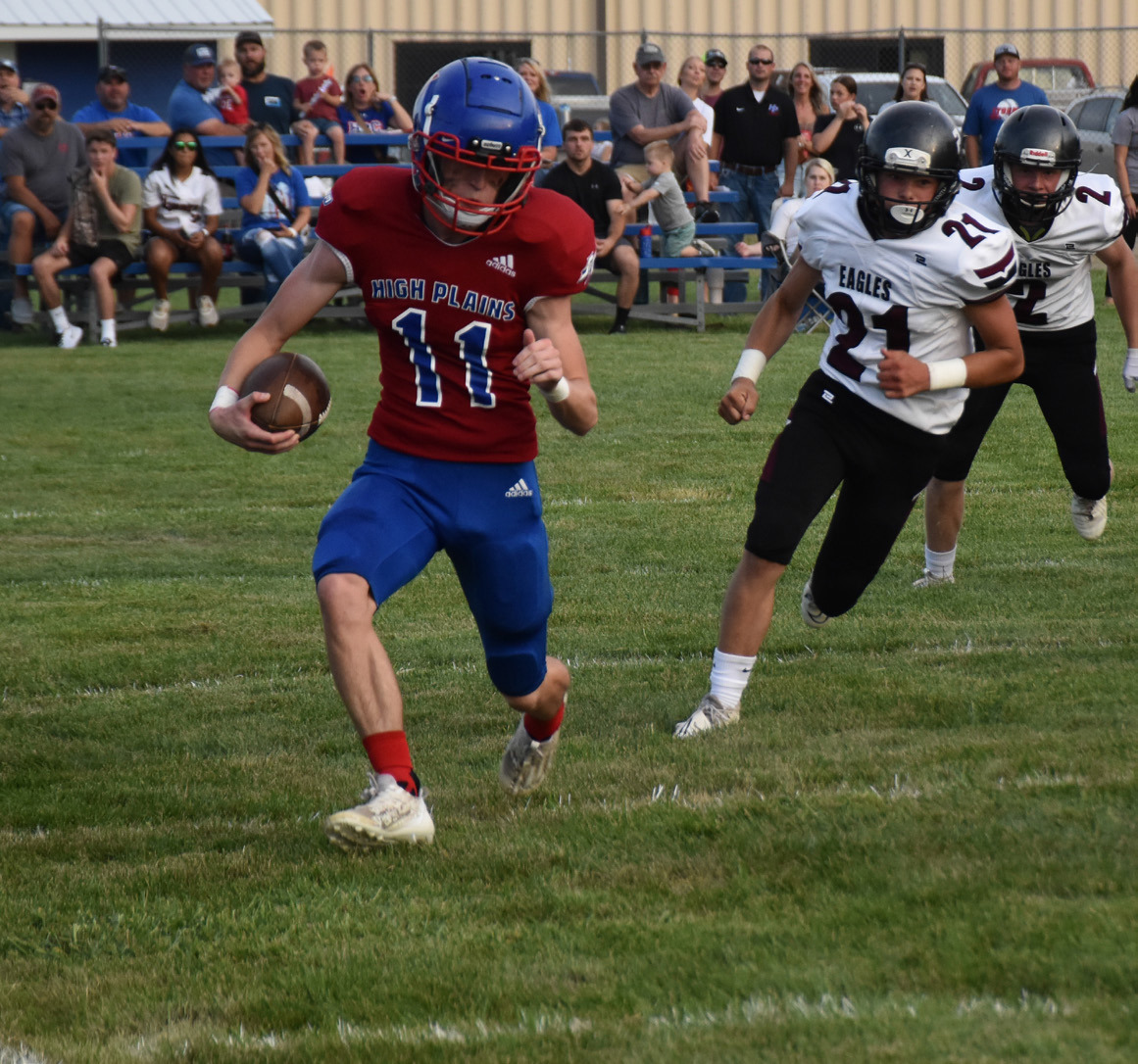 Gavin Morris runs the ball while being pursued by an Eagle defender. PCN photo by Beth Sparrow.