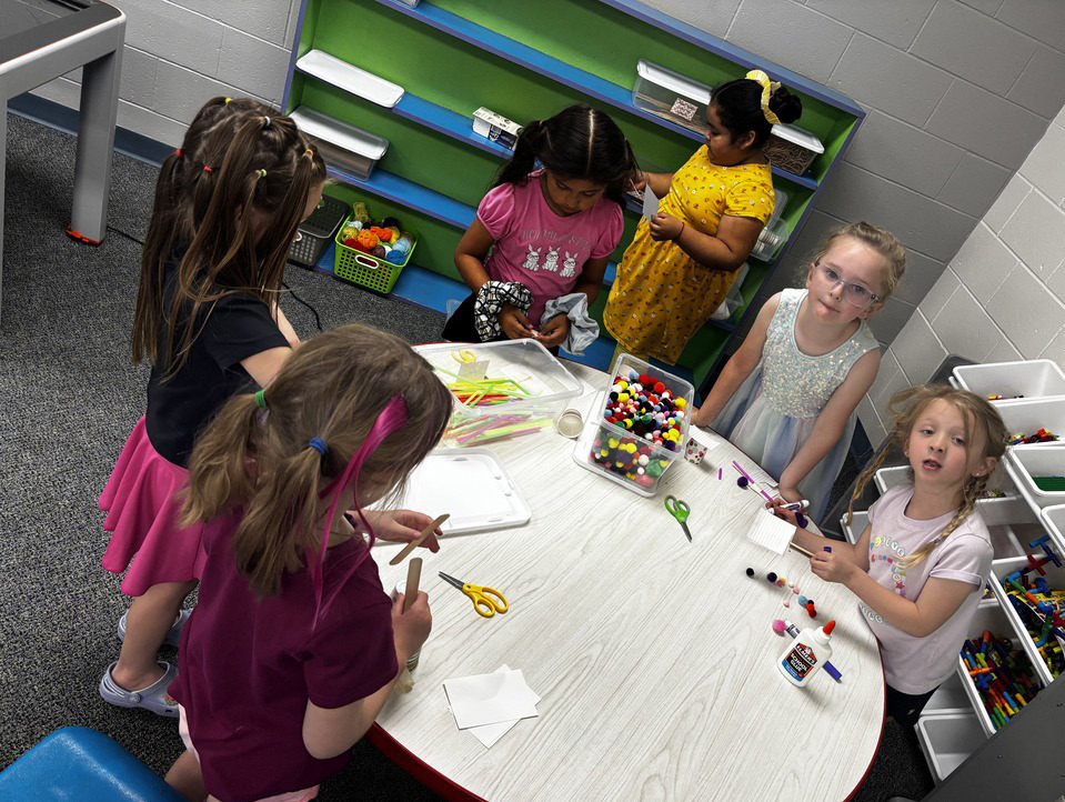 Above: HPC elementary students do some crafts in their last days. Below: HPC Kindergarten and First Grade visited the Lincoln Zoo last week. Here two boys sit in the O of Zoo while others are in front. Photos provided.