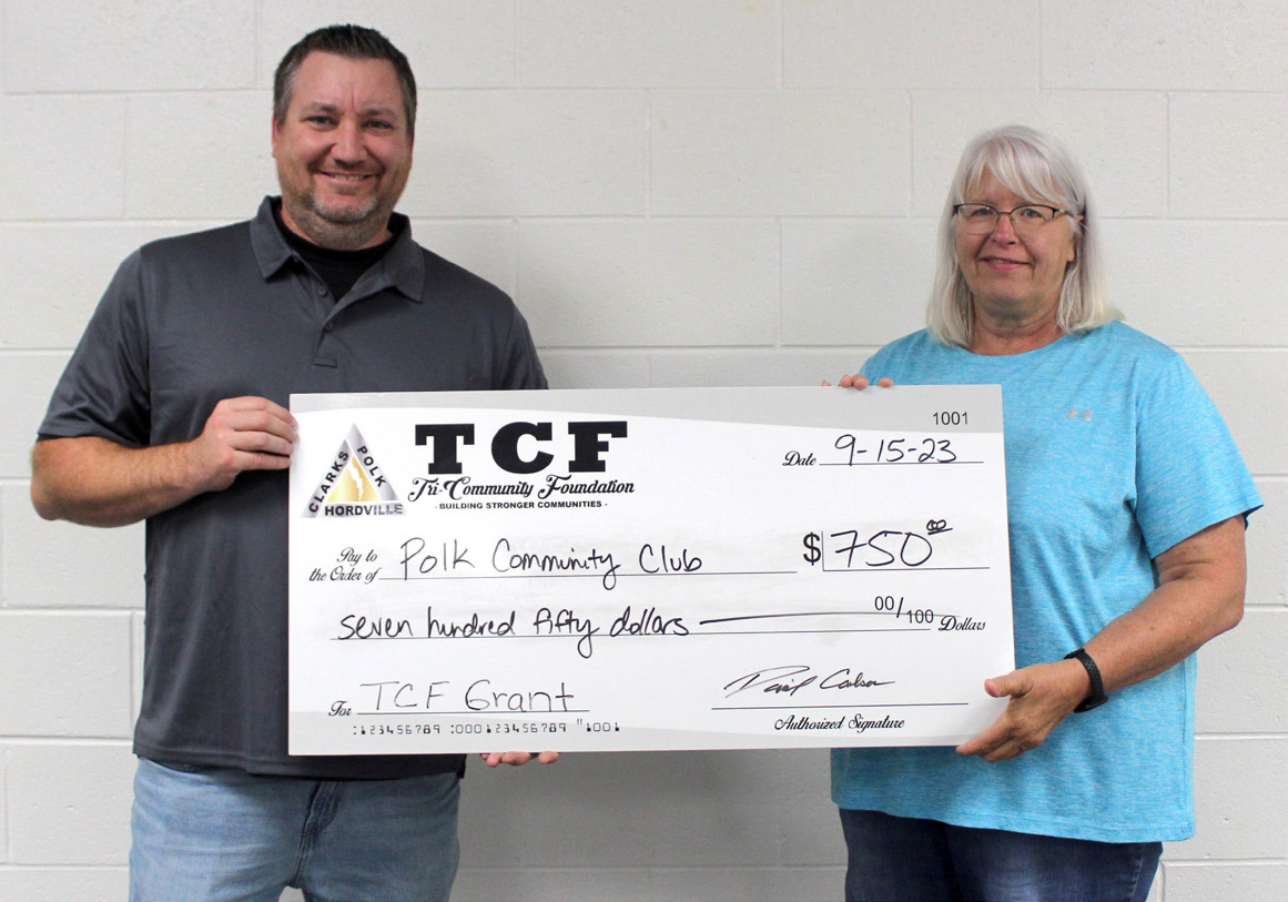Tri-County Foundation Awards held its annual check presentation. Receiving a grant was the Polk Community Club. Picture dis Nick Hatfield of TCF presenting the check to Kathy Carlstrom, club representative. Photo provided.