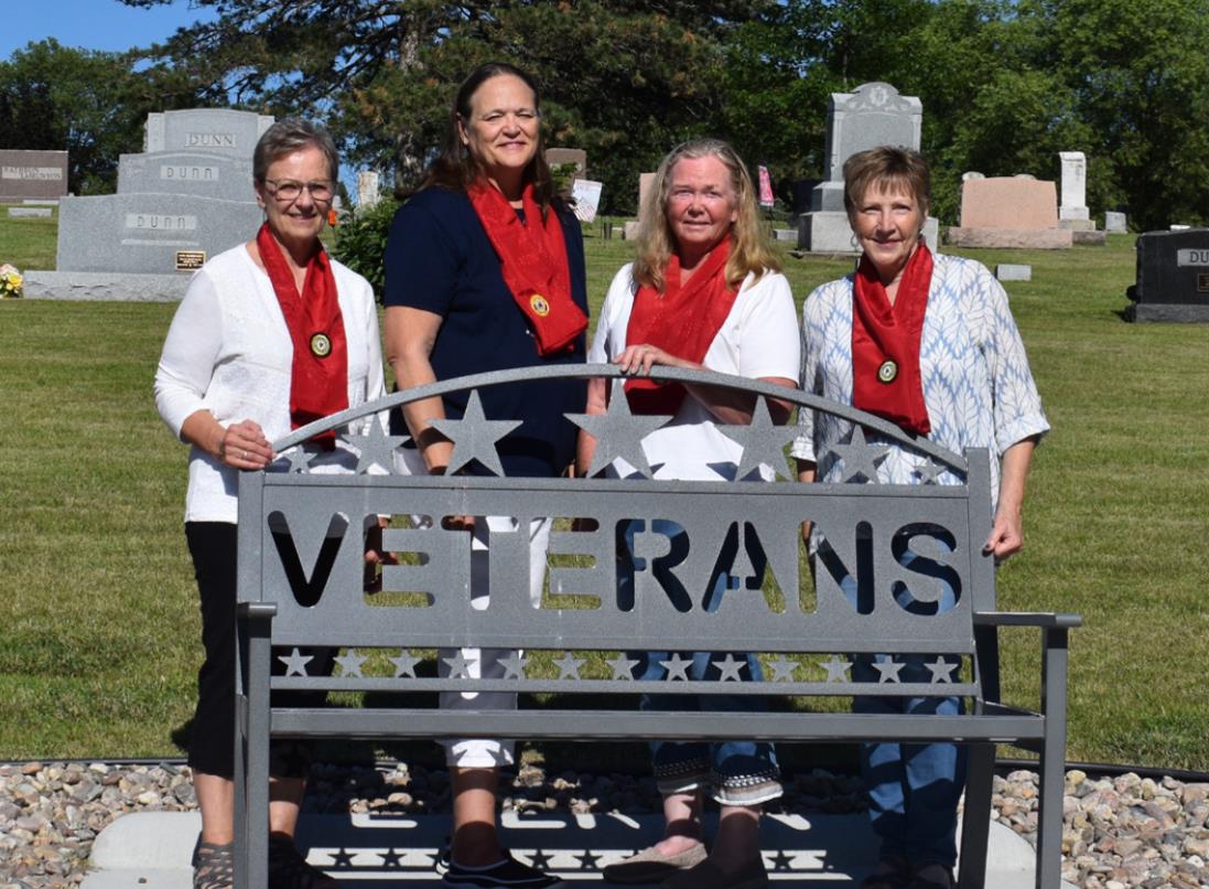 Roxanne Page, Linda Anderson, Lou Kresha and Kay Jones mark the dedication of the Legion Auxiliary veteran's bench. Photo by Beth Sparrow