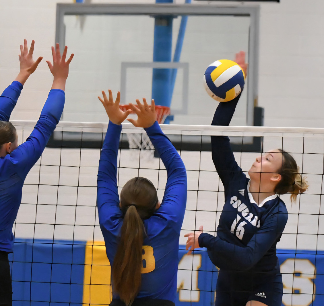 Cross County junior Ava Pruter (16) slams the attack into the Morrill Lions frontline defense during Saturday’s D1-4 final at Morrill High School. Pruter led the Cougars with 22 kills as Cross County earned their first state volleyball berth since 2022. Photo by Sandy Thompson.
