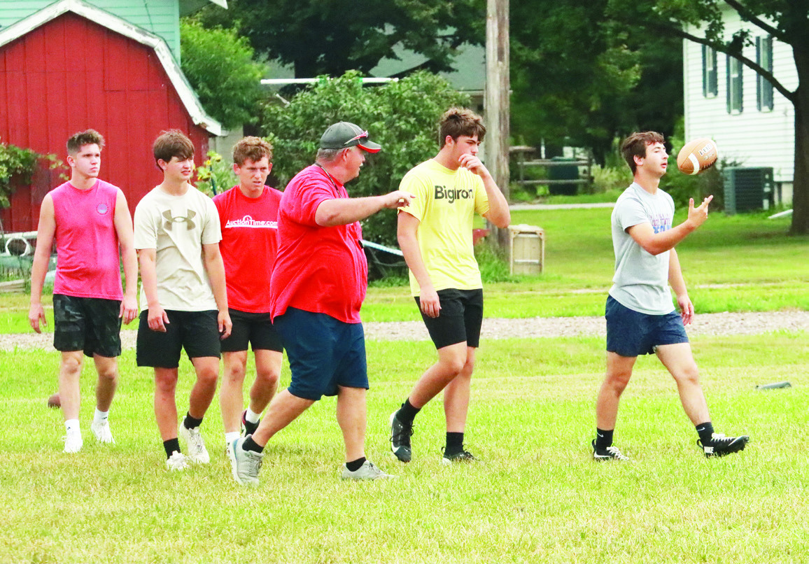 Coach Greg Wood (center) head coach of the of the High Plains Storm talks with his players as they practice for the upcoming inagural season of six-man football at High Plains. PCN photo by Ken Kush