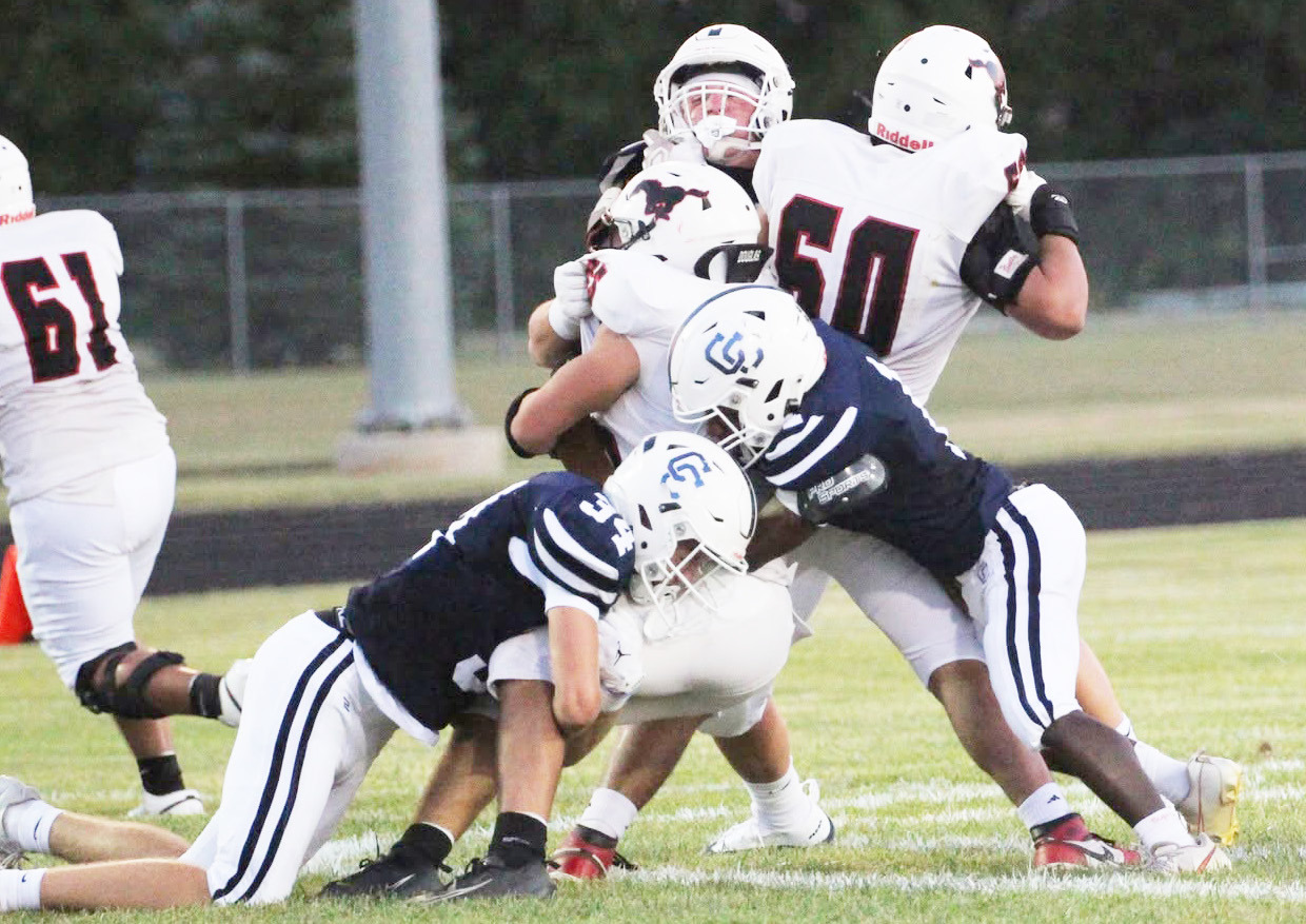 Top-Cross County’s defense collapses on the Sutton ball carrier. The Cougars had their hands full with a potent Sutton rush attack. Above-Eli Greenwall (3) looks for running room. PCN photos by Travis Lane.
