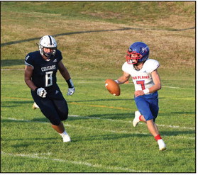 Haden Helgoth scrambles out of the pocket. PCN photo by Rick Holtz.