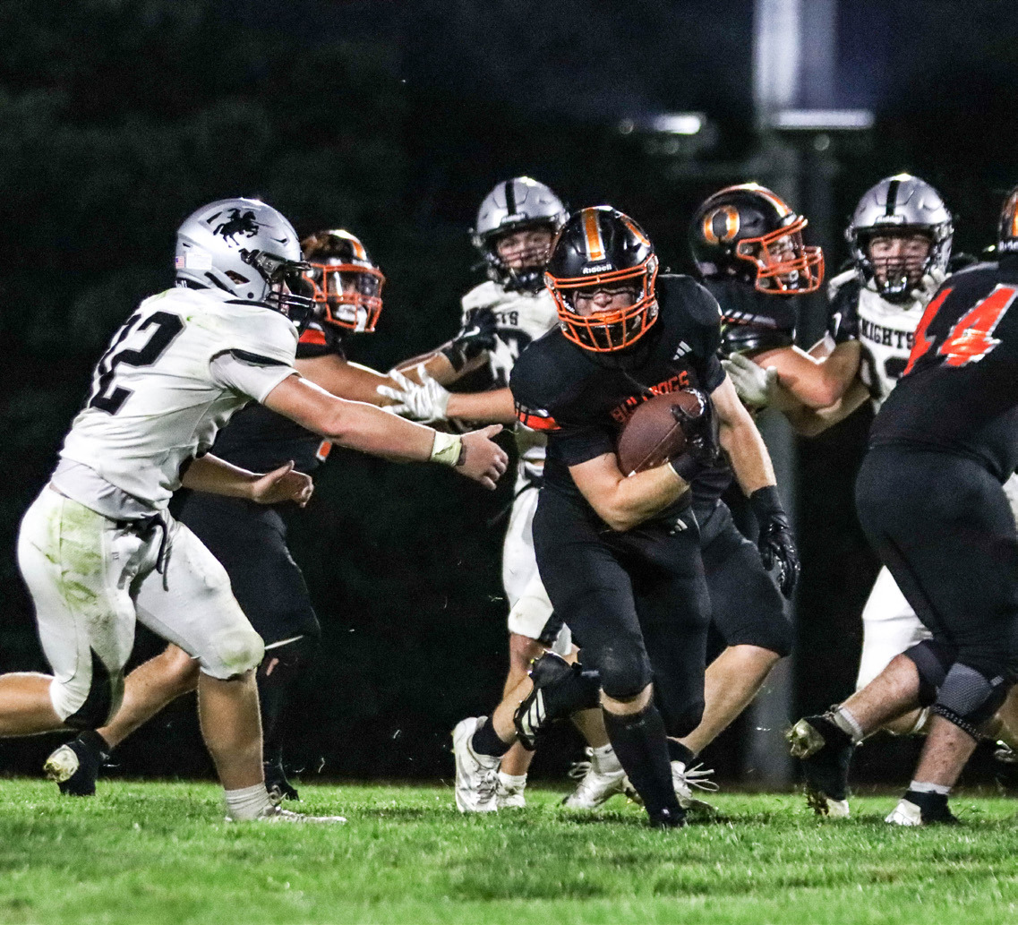 Above- Osceola senior fullback Aden Feezell breaks from the pack during the Bulldogs Friday night game in Osceola against the Elmwood-Murdock Knights. Feezell led the team in rushing with 77 yards on six carries and he also had a team-high 19 tackles.