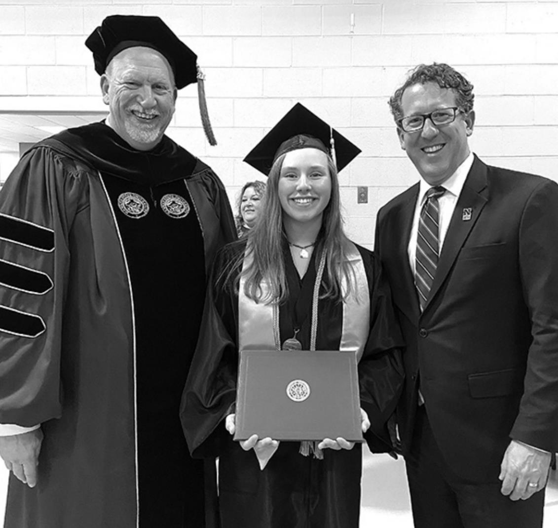 Pictured is the Dean of NCTA, Dr. Larry Gossen (left), Olivia Nyberg and Congressman Adrian Smith who had delivered the commencement address.