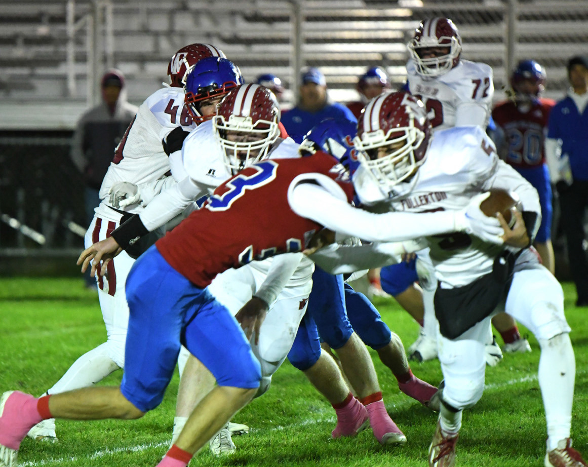 Carter Urkoski goes for the tackle and the football against Fullerton on Friday. PCN photo by Rick Holtz.