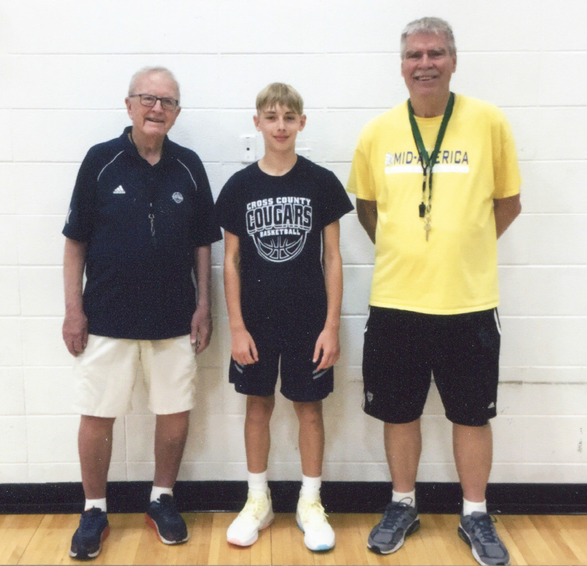 Cross County’s Eli Greenwall recently participated in Mid-America Basketball Camp at Grand Island Central Catholic. He is joined by Coach Larry Ribble and Coach Mike Trader. Photo provided.