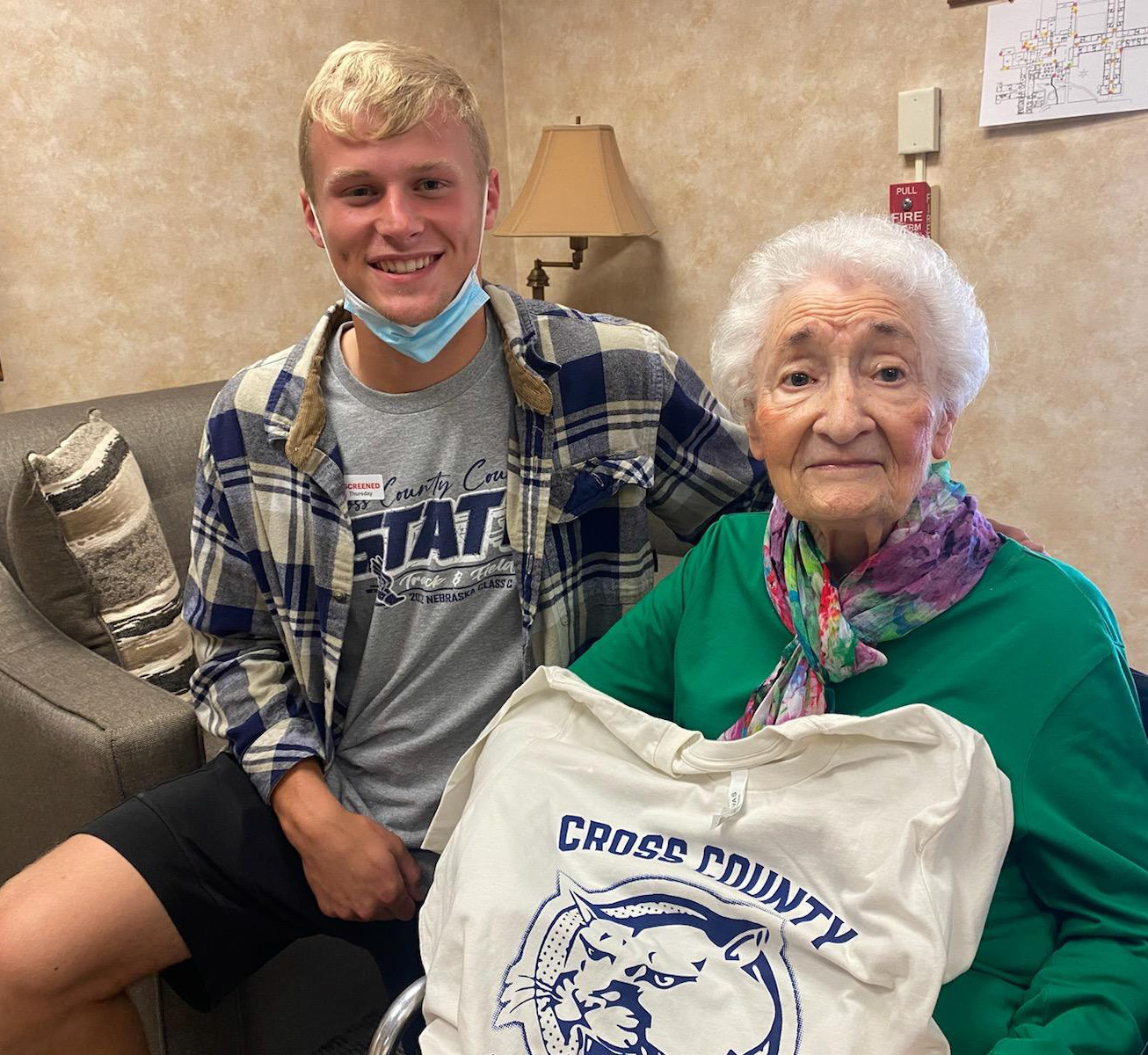 Donna is pictured with her great-grandson Jackson and her new Cross County t-shirt donated by the Cross County Booster Club. Photo provided by Erin Dickey.