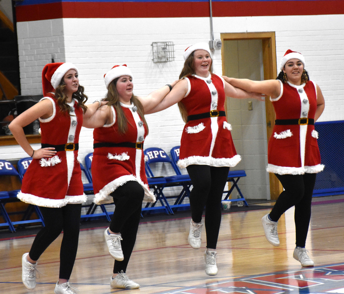The High Plains cheer and dance team performed at halftime of the Shelby-Rising City game and handed out hot chocolate packets to many lucky recipients. PCN photo by Beth Sparrow.