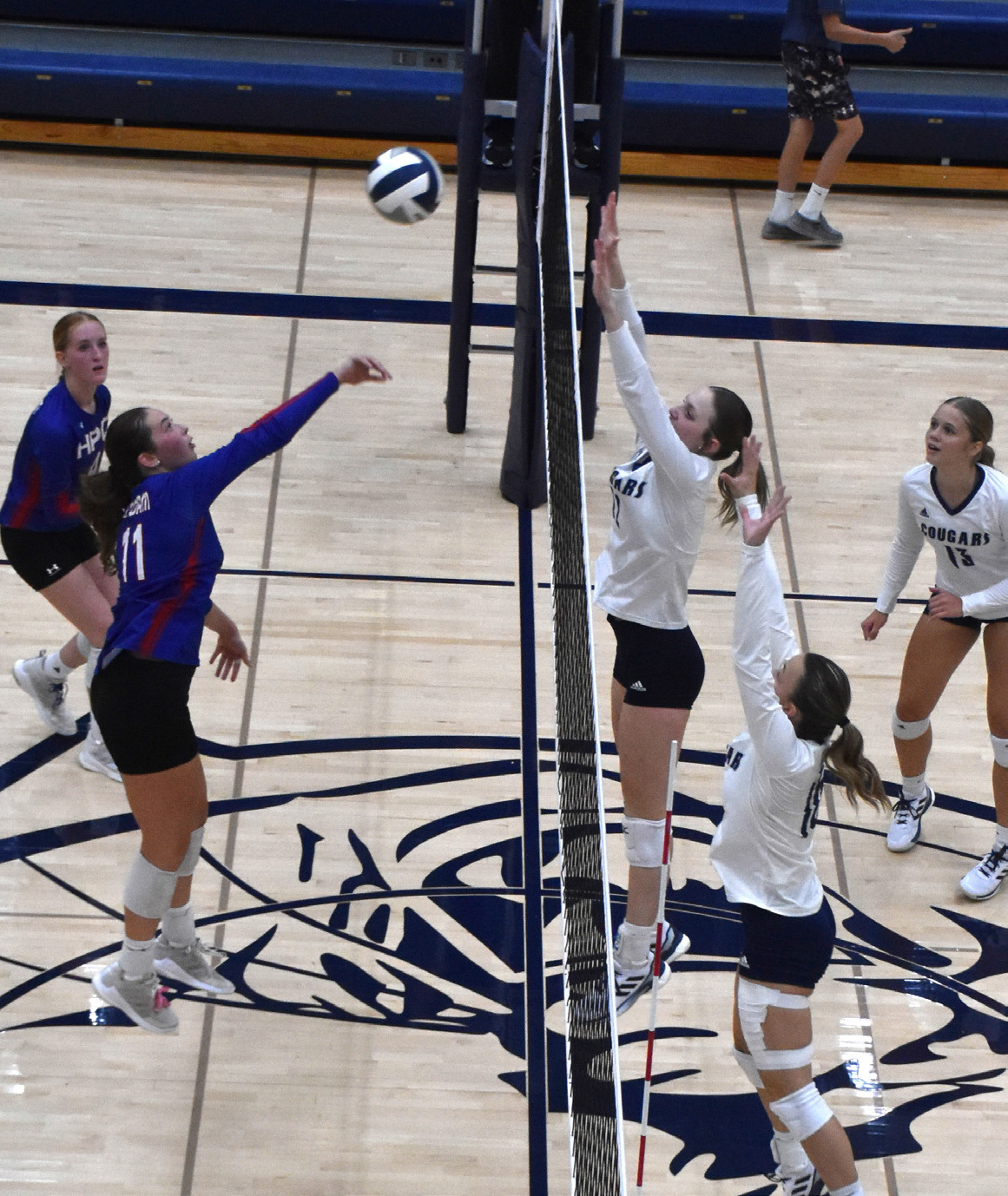 Rylee Ackerson tries to get a kill past the Cross County block of Bricelynn Larson. PCN photo by Beth Sparrow.