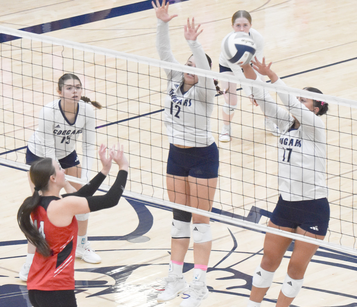 Cross County seniors Cortina Donnelly and Saphira Osentowski block the Meridian attack. PCN photo by Beth Sparrow.