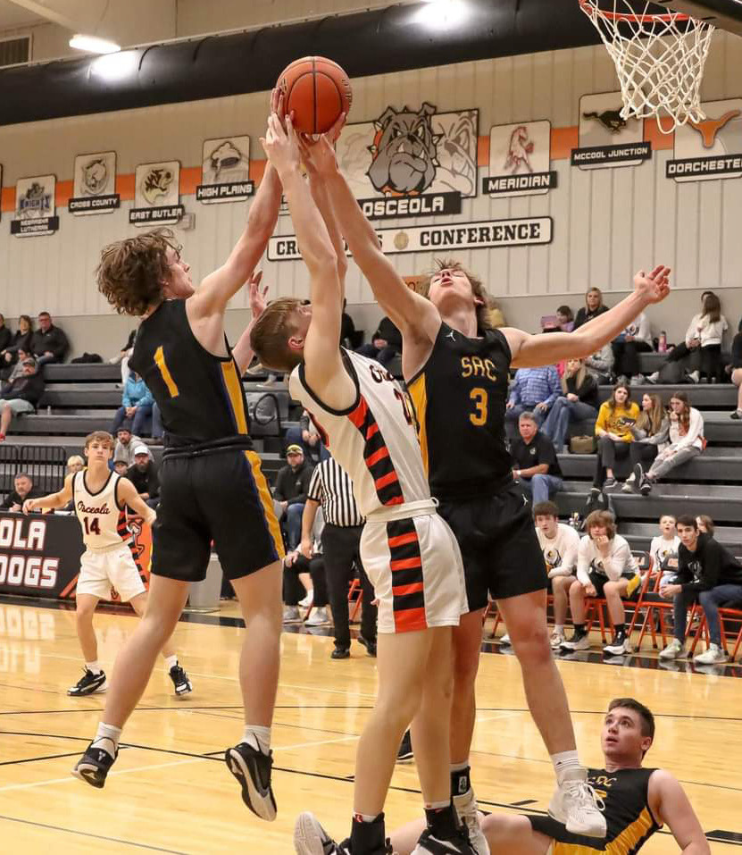 Gabe Dutton-Mofford and Dalton Pokorney (SRC) fight for the rebound against Braxton Mestl (OSC). PCN photo by Blaine Winslow.