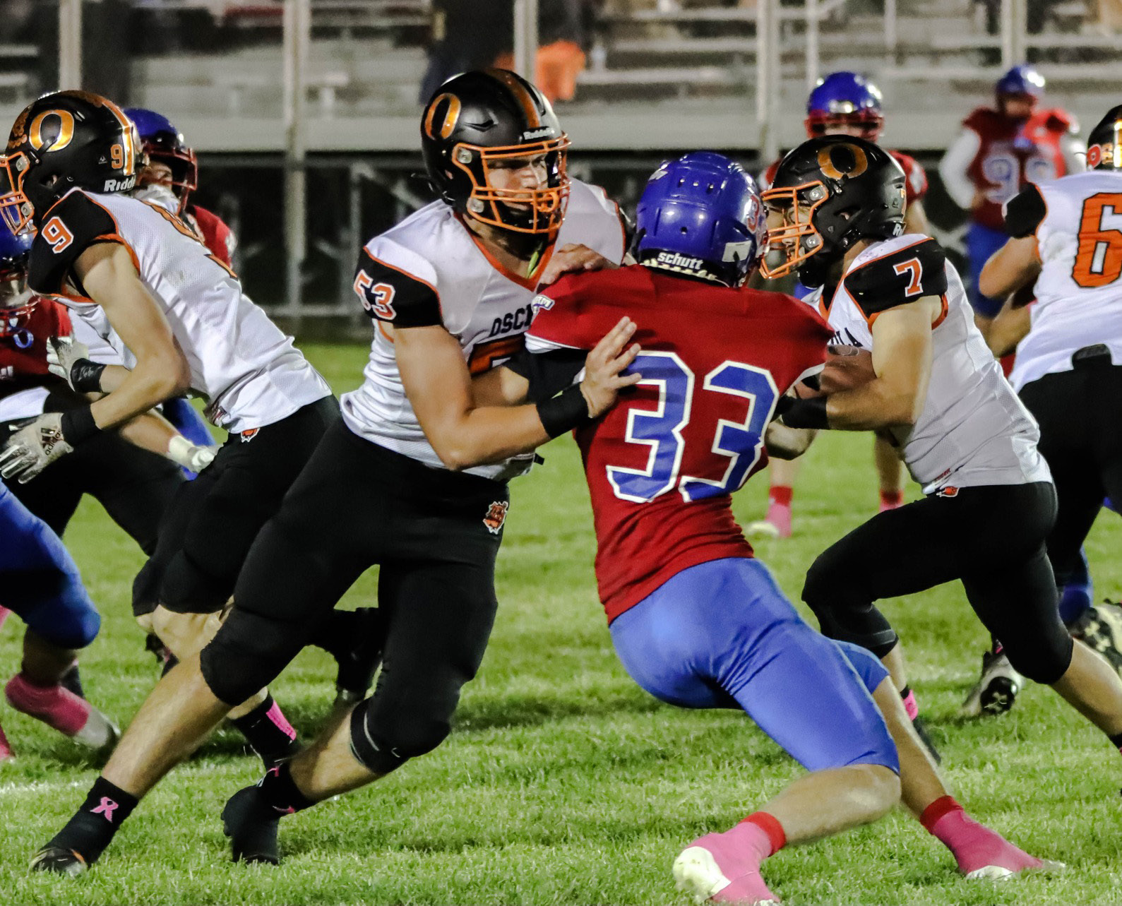 Creighton Sterup (OSC #53) blocks Carter Urkoski (HPC #33) so Matt DeMers (OSC #7) can run the ball. PCN photo by Blaine Winslow.