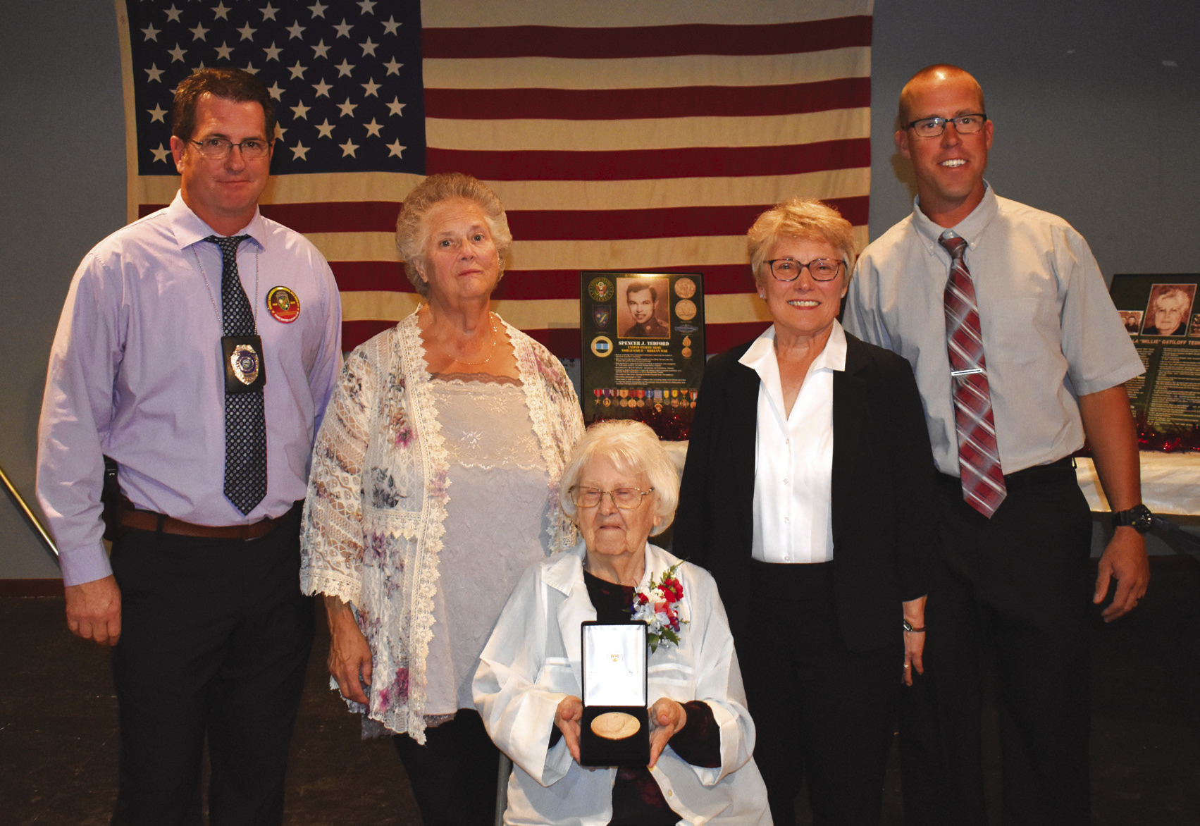 Spencer Tedford receives the Congressional Medal of Honor posthumously in Clarks on Tuesday. Receiving it for him was his wife, Ludmilla 'Millie' Tedford. Pictured left to right is Jason Morris, Sharon Russell, Mille, Barb Micek and Jarod Zoucha. PCN photo by Beth Sparrow.