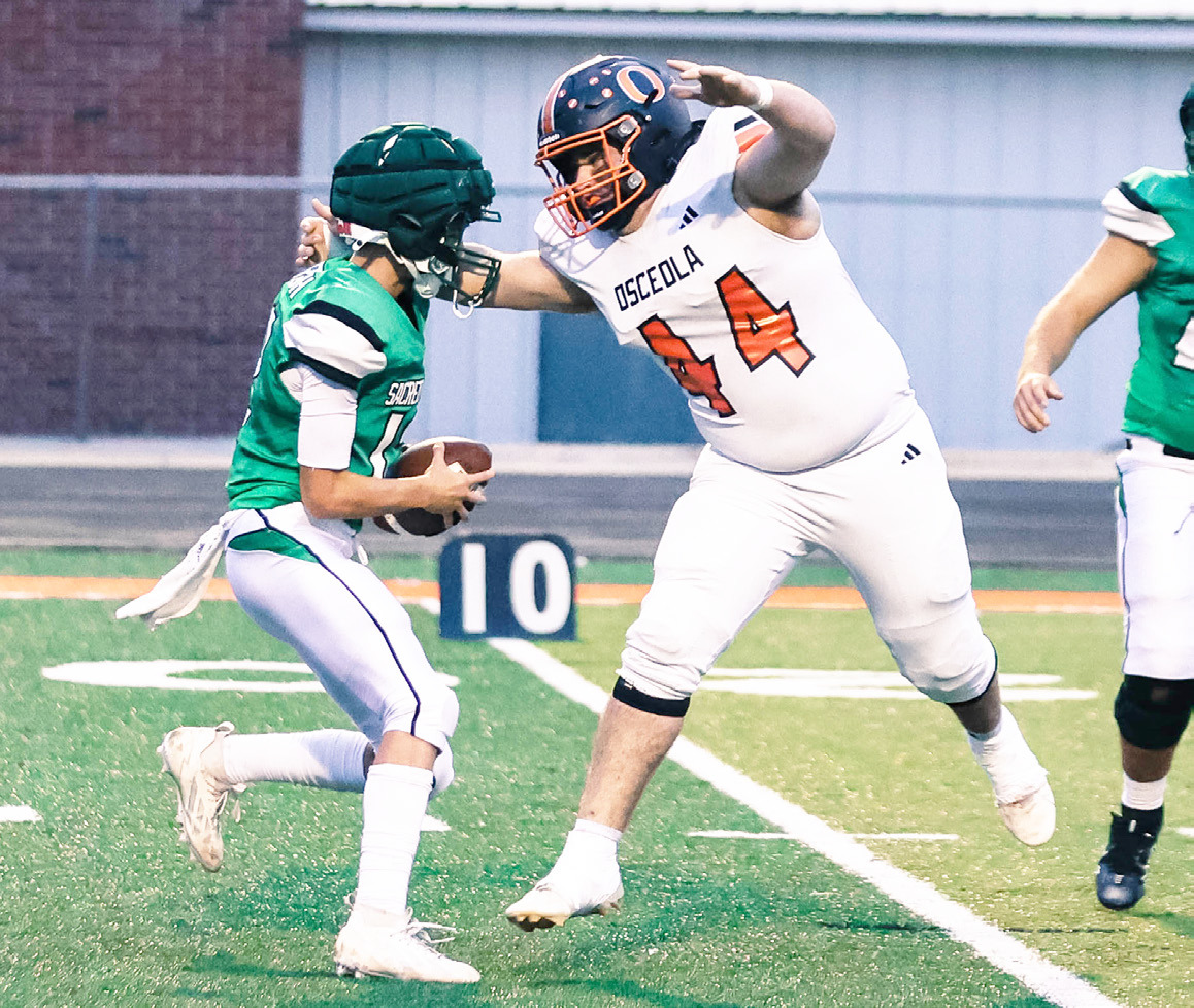 Osceola senior defensive end Cooper Yungdahl records one of his two sacks in the Bulldogs district opener at Falls City Sacred Heart. PCN photo by Blaine Winslow.