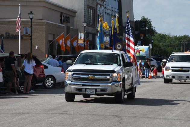 The Osceola American Legion carry the American flag at the beginning of the parade as it goes through downtown Osceola.
